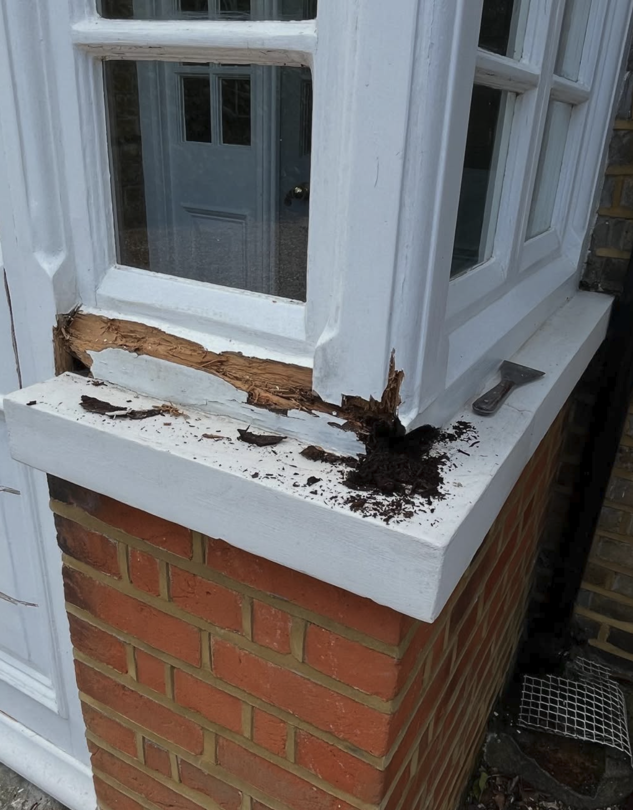 Before — Rotten bay window sill repaired and repainted, Exterior joinery · Hampton
