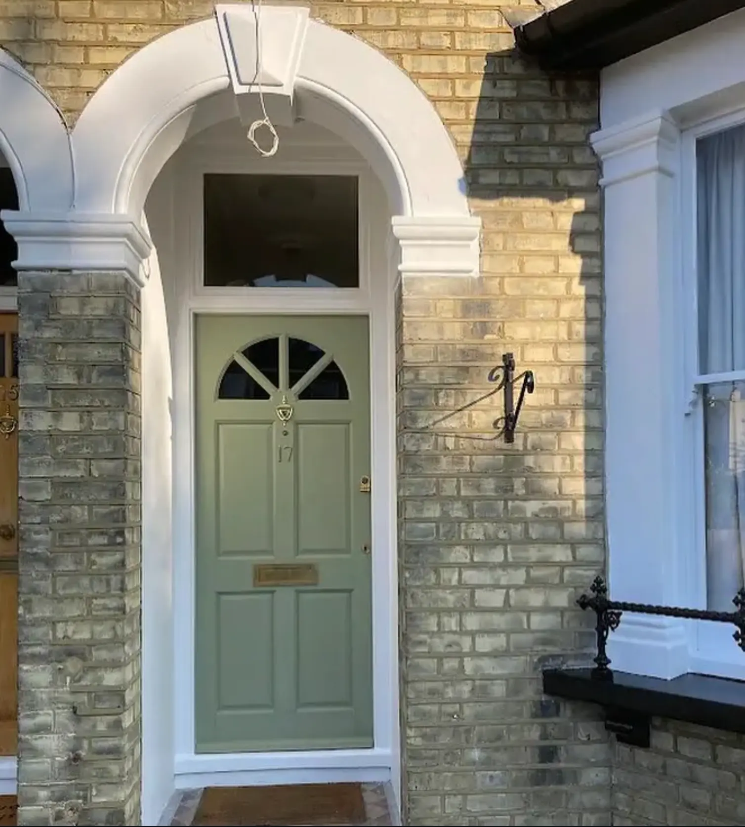 Victorian front door repainted in sage green with white porch mouldings, Hampton
